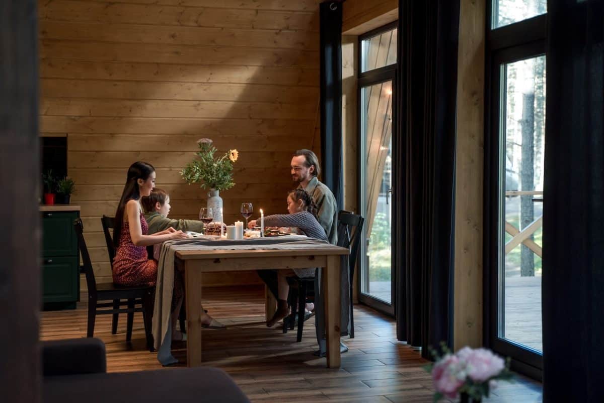 Mother and father having dinner and trialling separation in the same house with kids