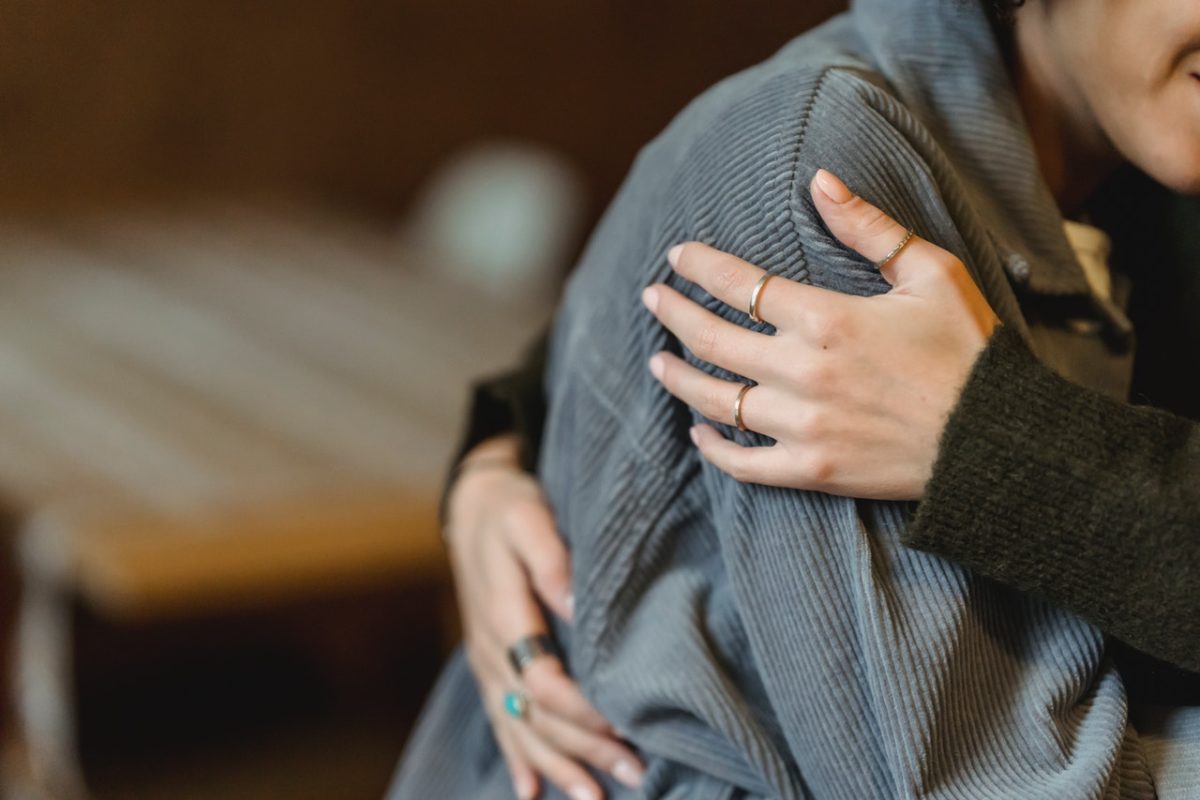 Woman embracing and hugging friend after seeking AVO restraining order