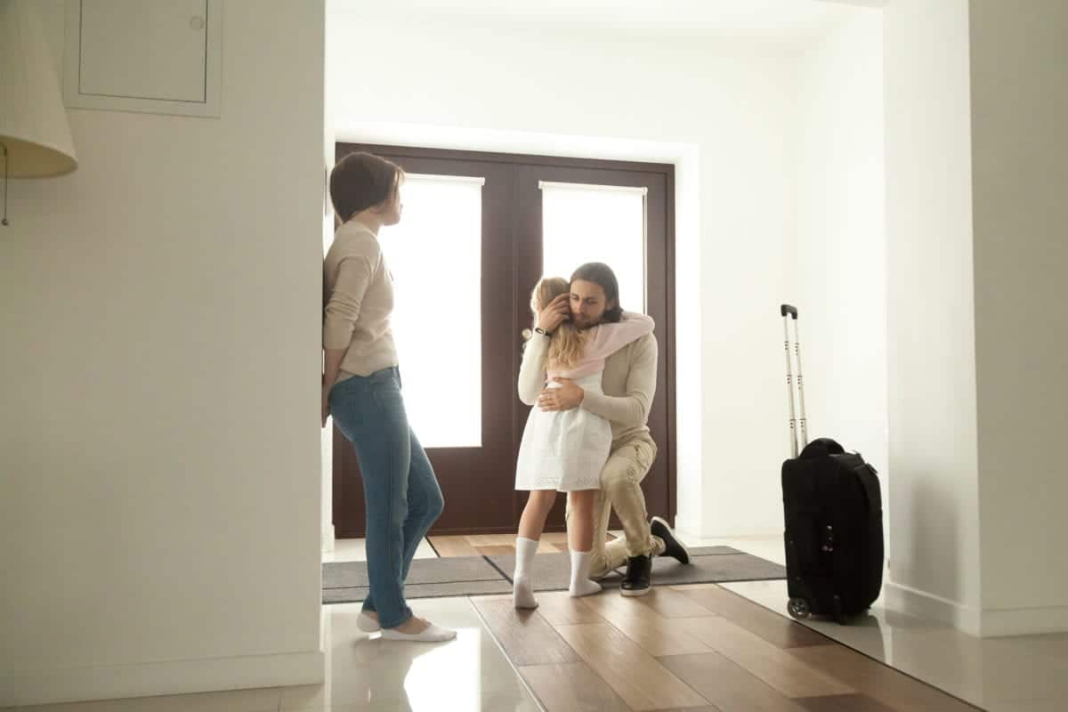 Father hugging children after visiting divorce lawyers in Australia to make child arrangements