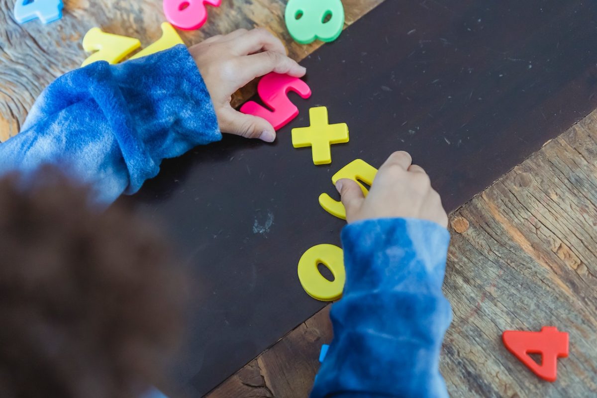 Child playing with toys waiting for parent to file contravention application.