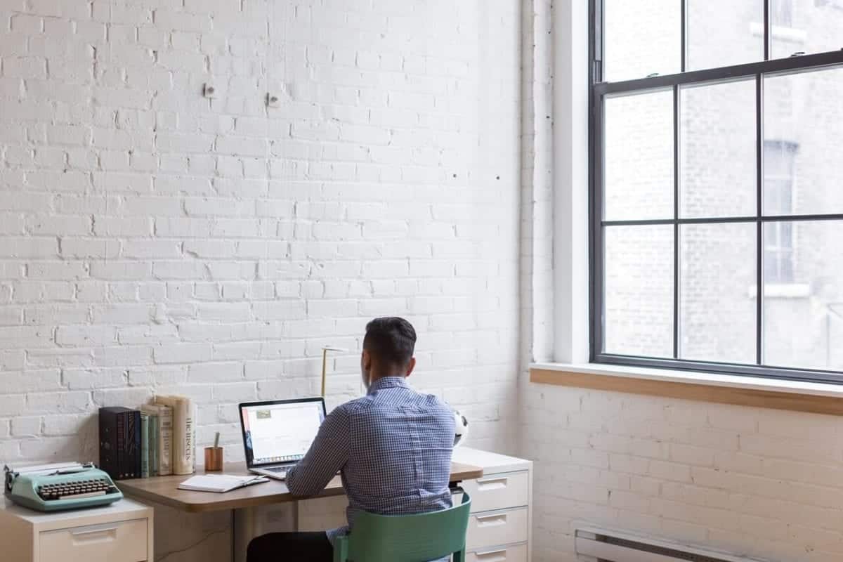 man in home office attending virtual courtroom